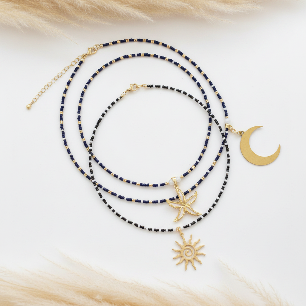 Colliers en perles bleu foncé avec breloques dorées : lune, étoile de mer, soleil