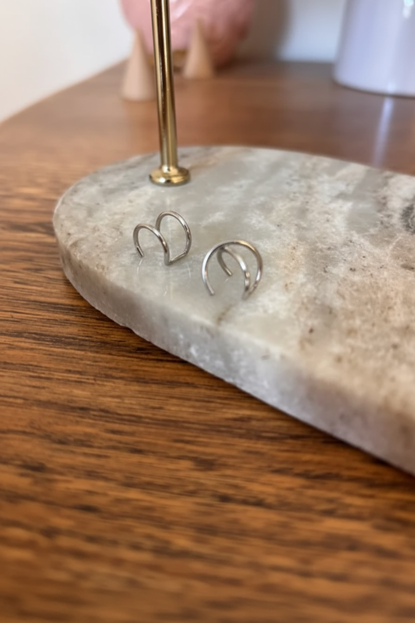 Deux boucles d’oreilles à enfiler argentées, anneaux ouverts en forme de nœud